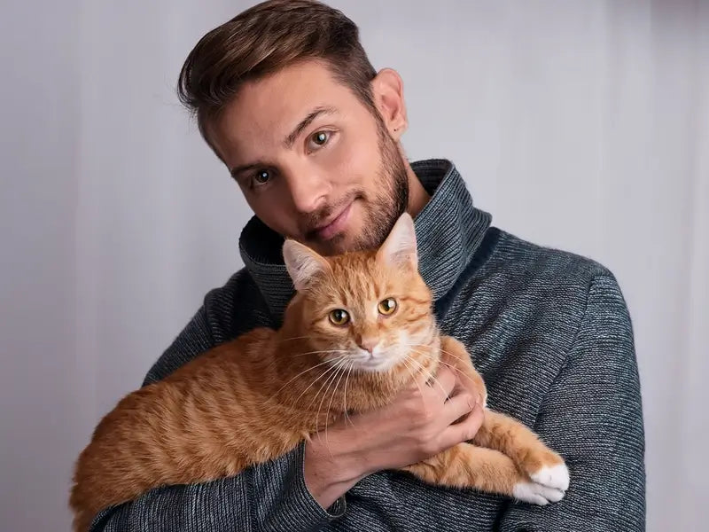 Jayden Castanos Holding a Cat With Arthritis - Blog Author